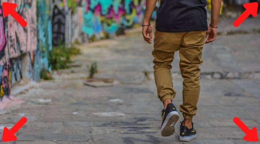 wide angle shot of a dude walking with a skateboard