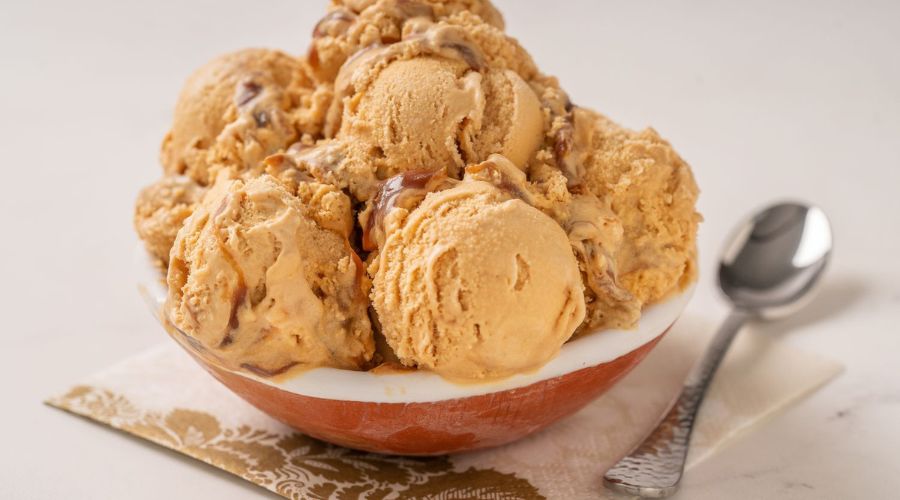 close-up photo showing the rich texture and vibrant colors of a melting scoop of ice cream